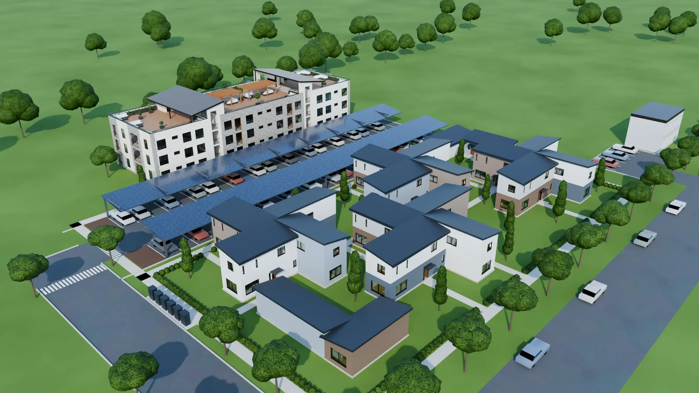 Aerial view of Medford Phase 1 from the southwest: twenty homes around garden walks, the covered solar parking, and Building 18 with its roof decks